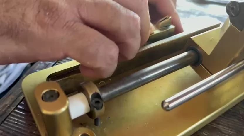 Hands centring and securing oboe cane in a gouger bed
