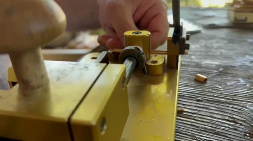 Oboe cane being secured with the end clamp of a brass gouger